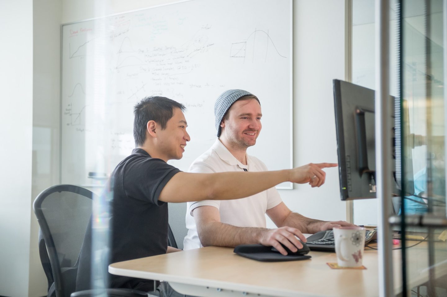 Two people working at a computer, representing Saskatchewan’s competitive incentives and tax advantages.