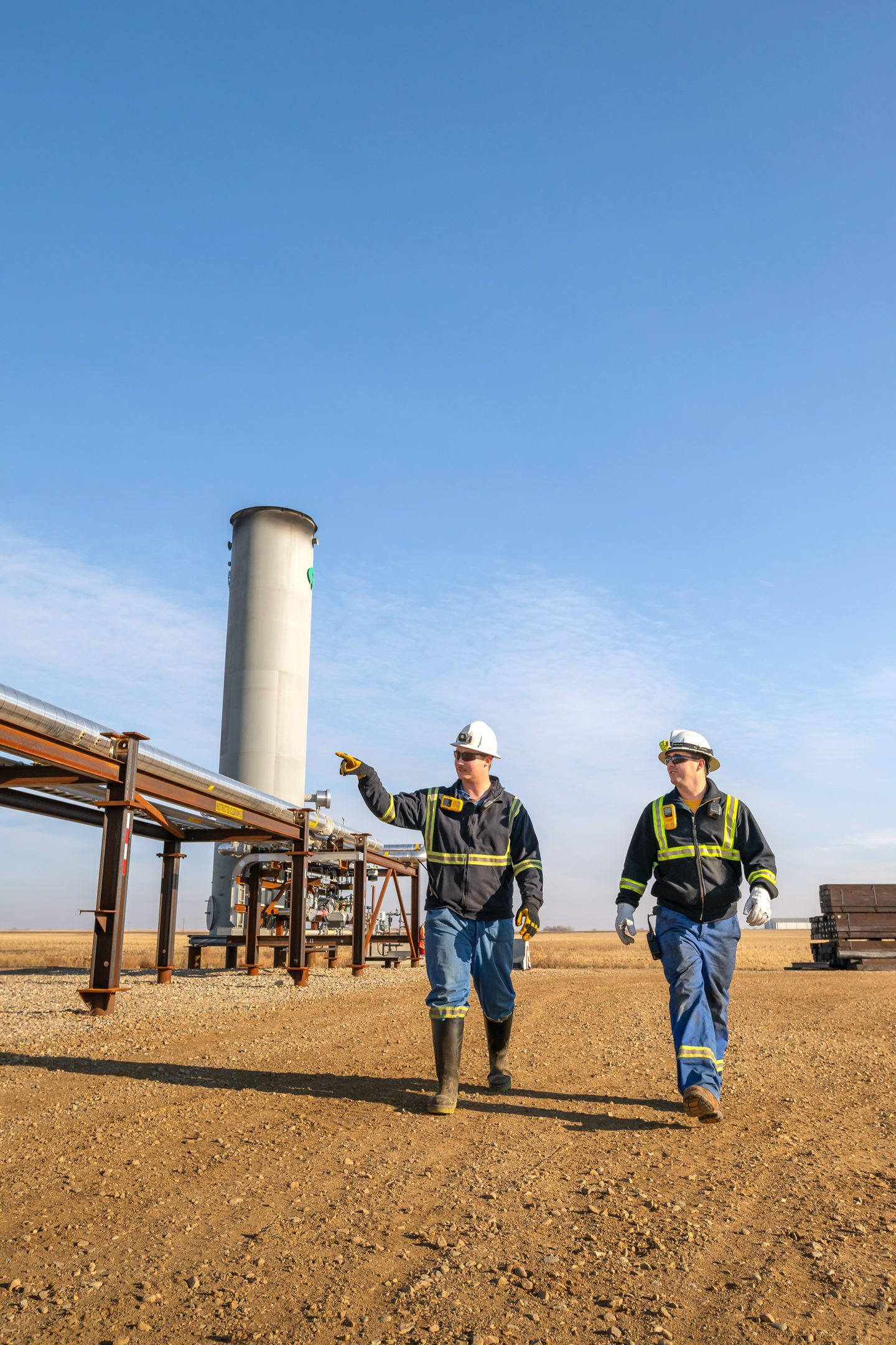 Two workers walking through an energy site, representing Saskatchewan’s extensive natural resources.