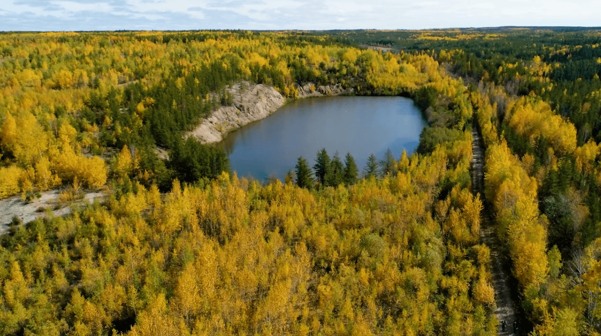 A view of Cluff Lake surrounded by developed natural landscapes, illustrating sustainable environmental management in the area.