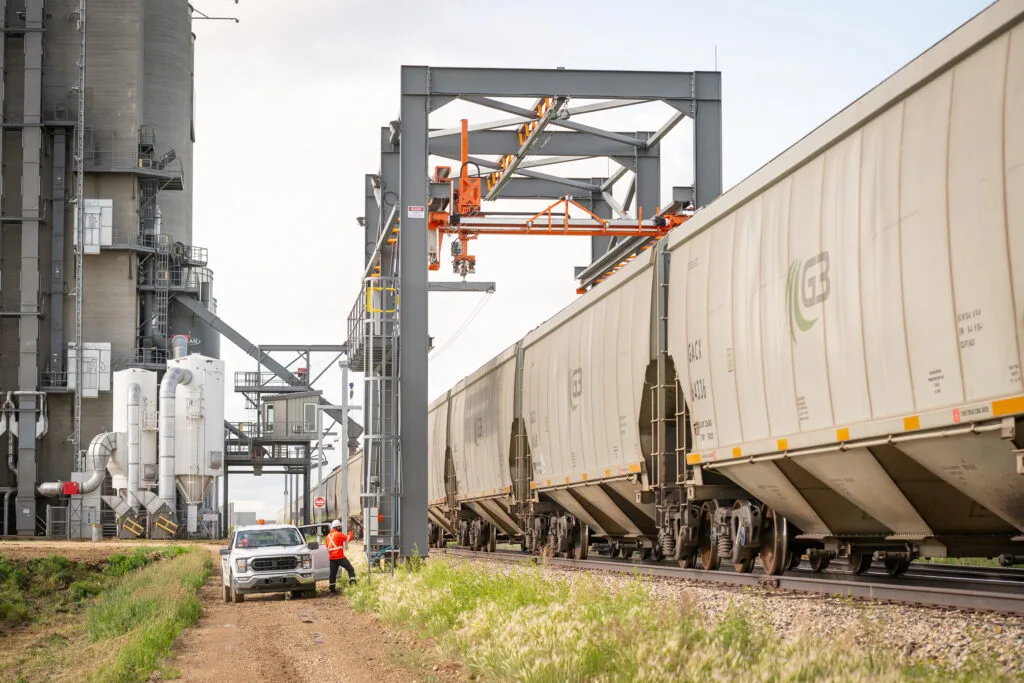 A worker inspecting Railhawk technology along a rail line, representing Saskatchewan’s advancements in transportation technology and infrastructure.