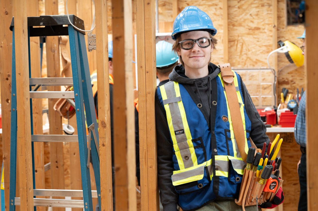a construction worker in safety gear at a building site.