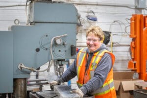 Manufacturing worker operating industrial equipment.